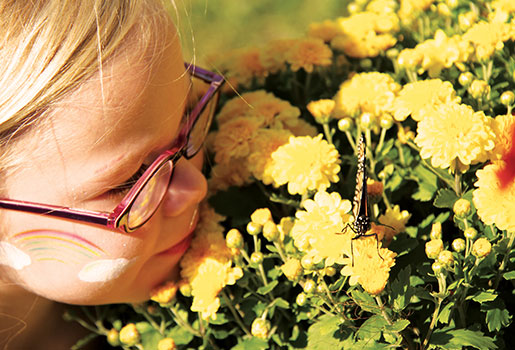 Young girl looking at butterfly