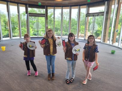 Four girl scouts posing with their crafts.