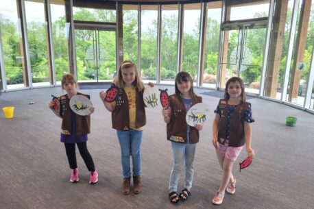 Four girl scouts posing with their crafts.